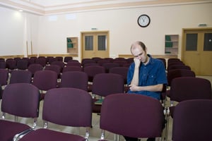 succeed with virtual conferences - a man bored in an auditorium